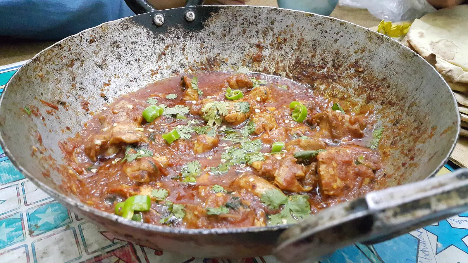 Chicken karahi cooking in a large wok