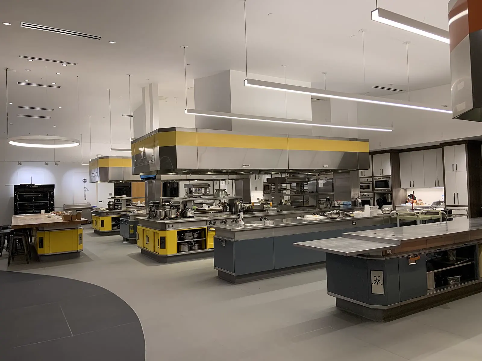 A large professional kitchen with steel work counters
