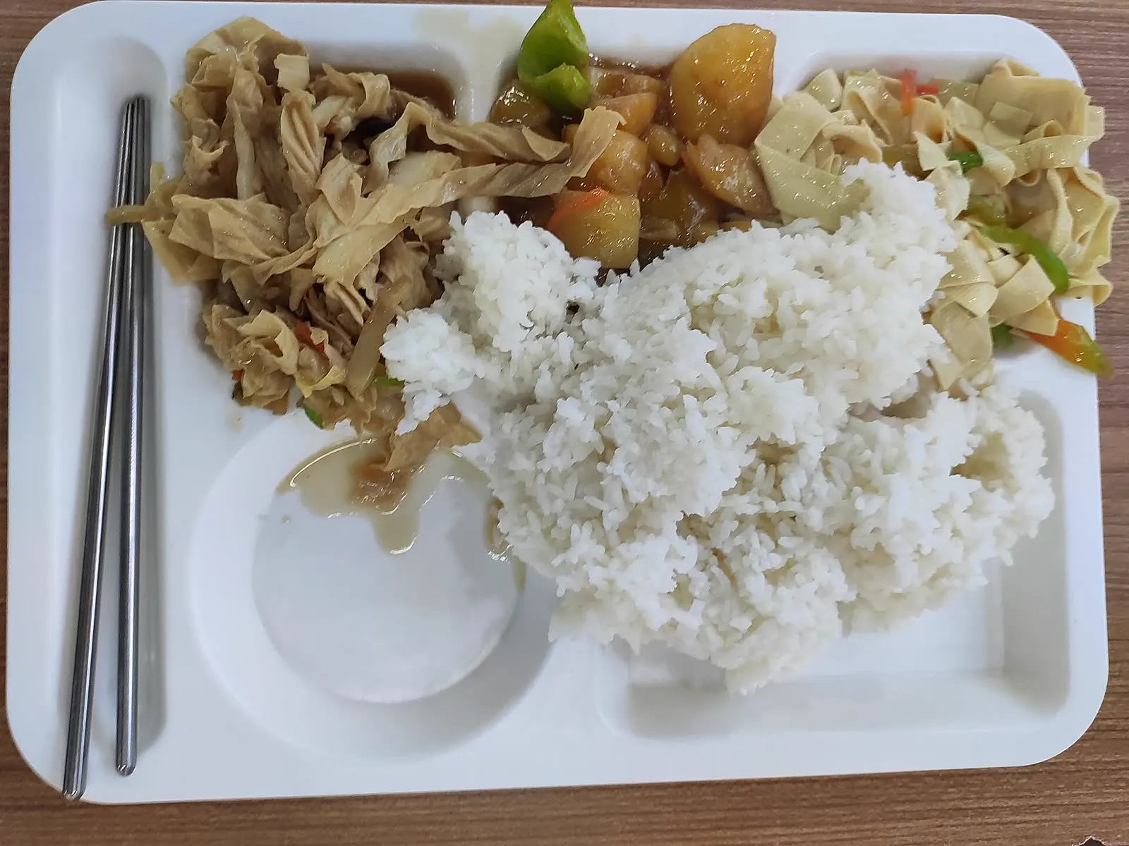 A canteen tray with rice and side dishes